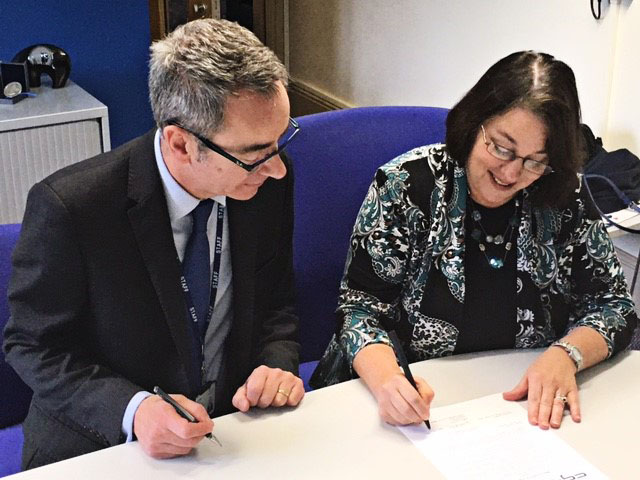 Professor Robert Aitken, the Academic Deputy vice chancellor for York St John University and Dr. Amy Holloway, vice president of Academic Affairs at CGTC, sign the Memorandum of Agreement (MOU) which could see CGTC students earn higher-level degrees in Great Britain. 