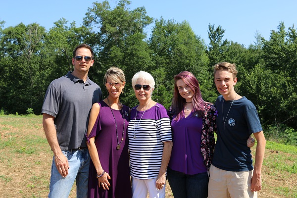 [Photo] The family of Parker Killian Moore gathers following a ribbon cutting for a trail named in Moore’s honor in Warner Robins. The family of his mother, Leah Heaton Maas, raised funds following his shooting death at Barberitos restaurant on Watson Boulevard in January and is now giving back through scholarships in his honor. 