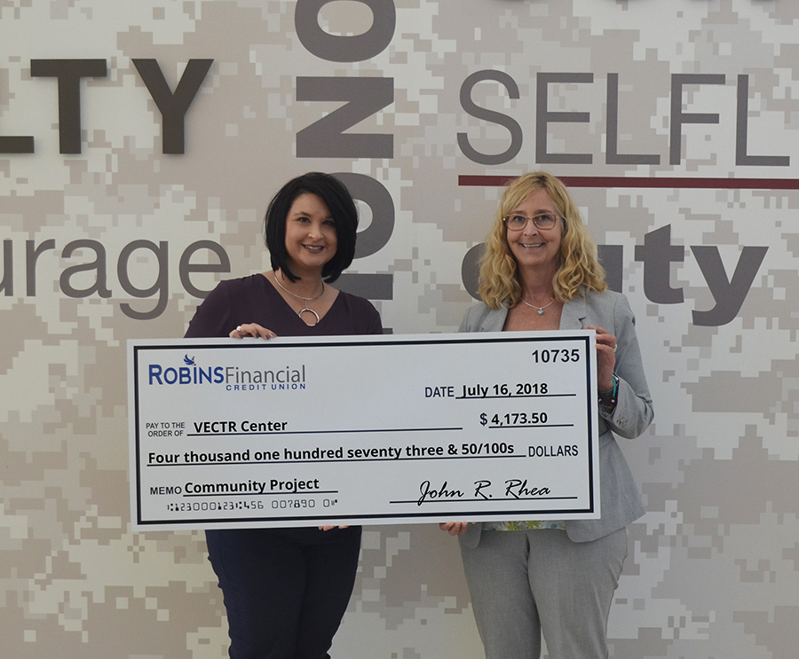 Executive vice president for Robins Financial, Christina O’Brien, presents a check to the Georgia VECTR Center’s chief operating officer, Col. Patricia Ross (Ret.).