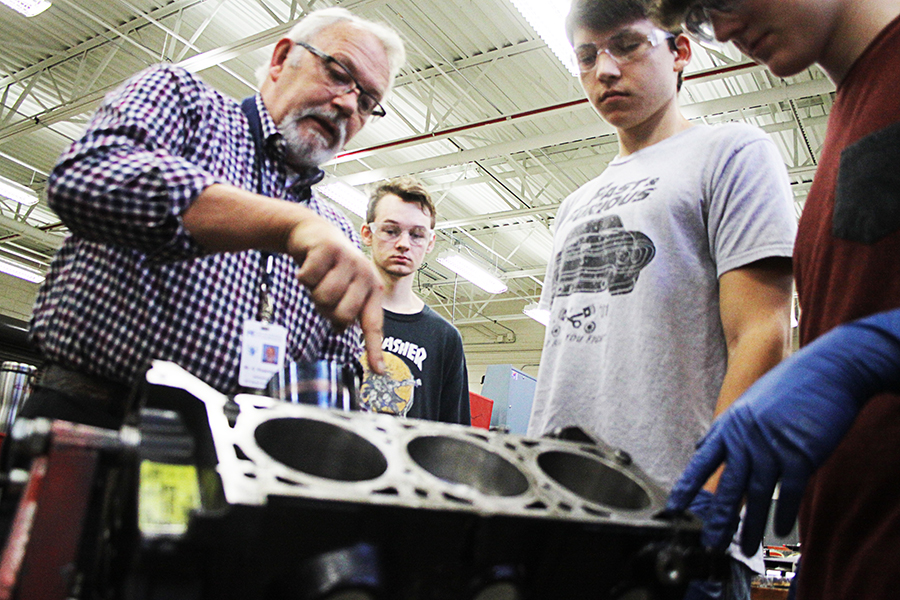 CGTC Automotive Technology instructor, George Rosenblad (left) explains techniques for the repair of a piston to his Dual Enrollment students (from left to right) Tristan Weddington, Joseph Lopez, and Chance Schooley, in the automotive lab at Houston County Career Academy. 