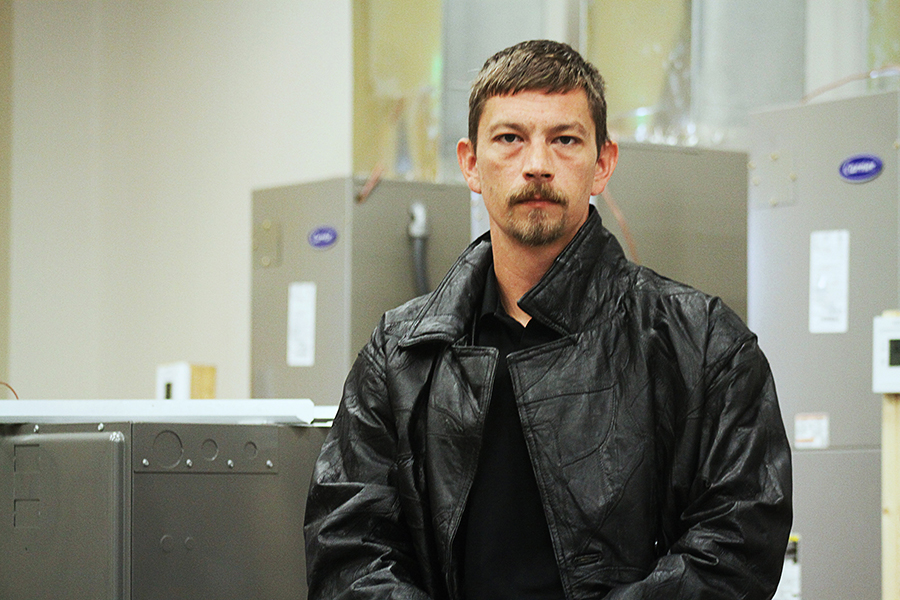 Jeremy Steen stands in the air conditioning lab. 