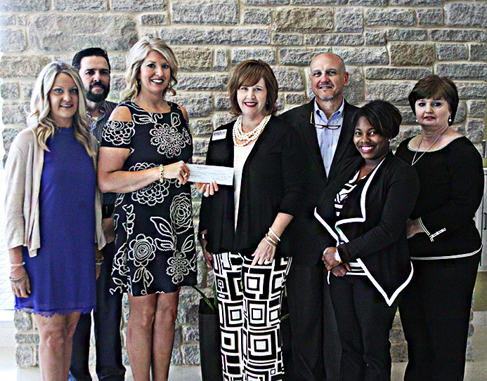 (From left to right) Milledgeville Exchange Club treasurer, Lynde Schubert, president-elect Jeffrey Wells, and president Tori Allen, join CGTC assistant vice president for Advancement, Tonya McClure, CGTC Board of Trustee member, Hank Griffeth, CGTC advancement coordinator, Carmen Davis, and vice president of Satellite Operations at CGTC, Dana Davis, for the scholarship check presentation. 