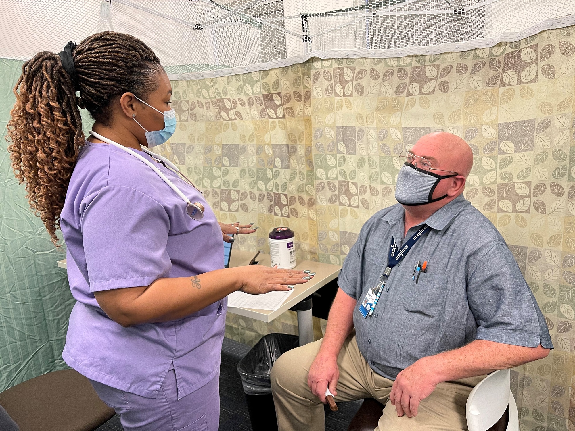 VA Nurse speaks with Electrical Technician instructor, Don Webb about the vaccine. 