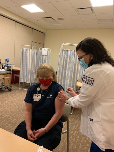 CGTC RN student administers vaccine to a patient in Houston Healthcare’s vaccine clinic. 