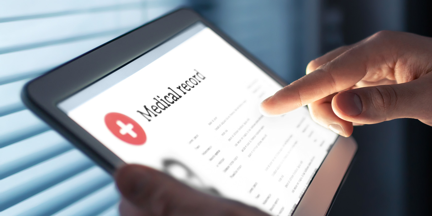 Hand tapping tablet with "Medical Record" on the screen