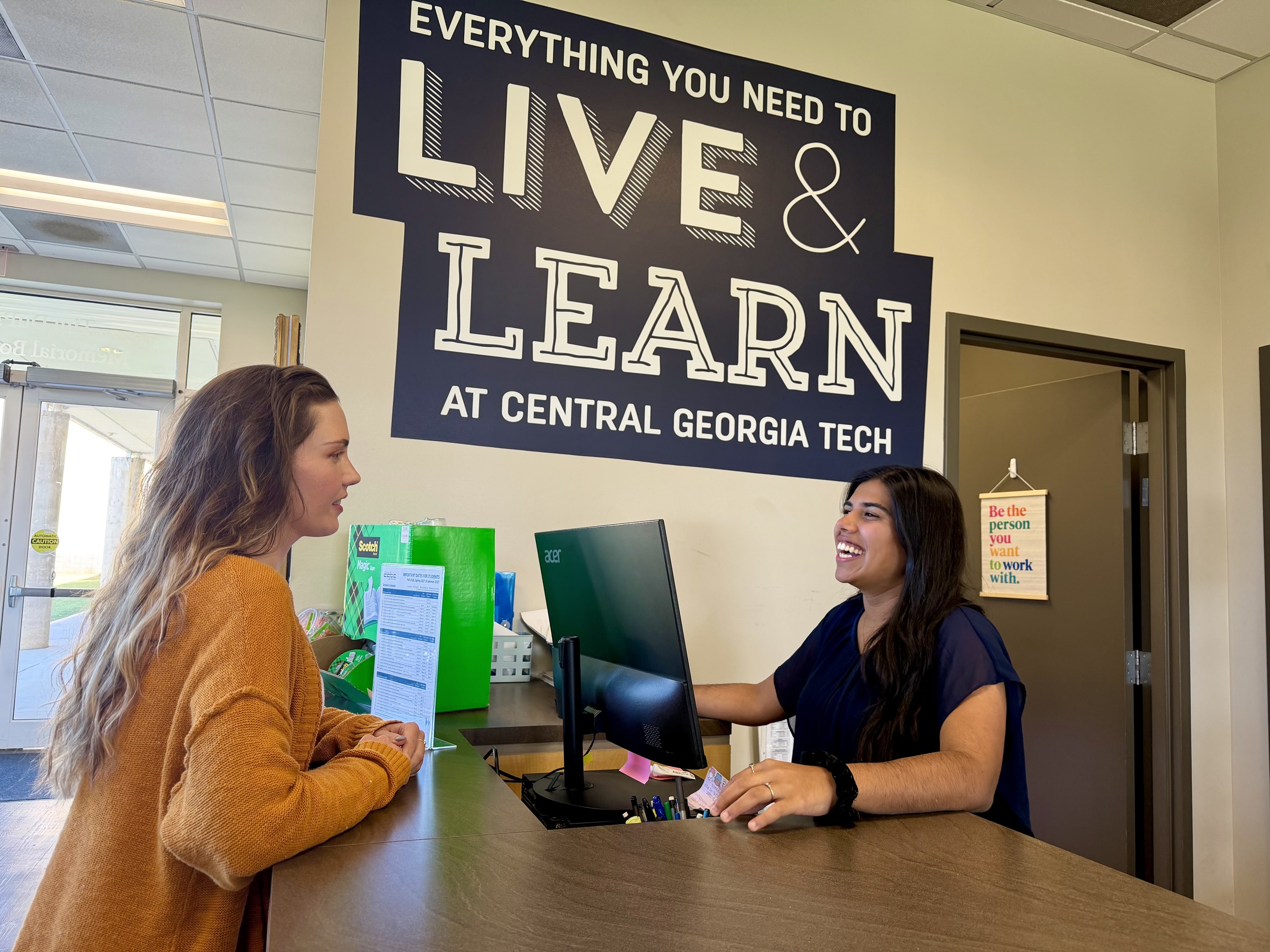 Sophomore Business Management student Niyati Davey (right) helps students with book purchases at CGTC's Bibiliu Bookstore on the Warner Robins campus. 