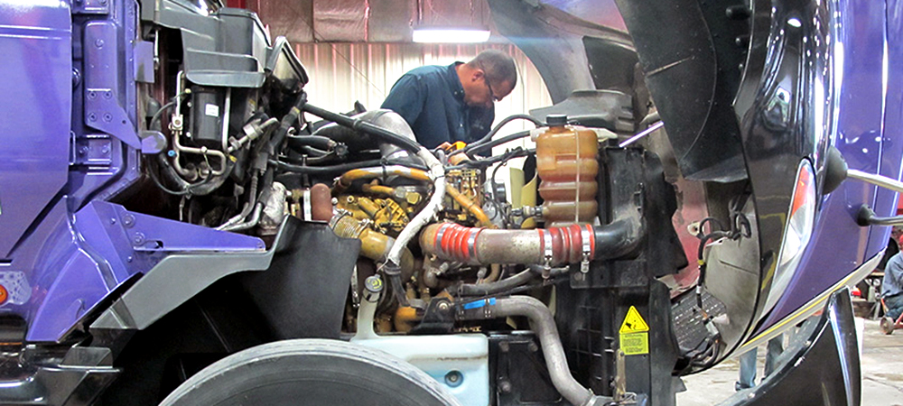 Diesel truck maintenance student working on truck