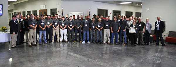 Photograph of Interfor Event. State officials, Interfor apprentices, CGTC staff and Interfor representatives gather to recognize the beginning of the Millwright Apprenticeship Program.