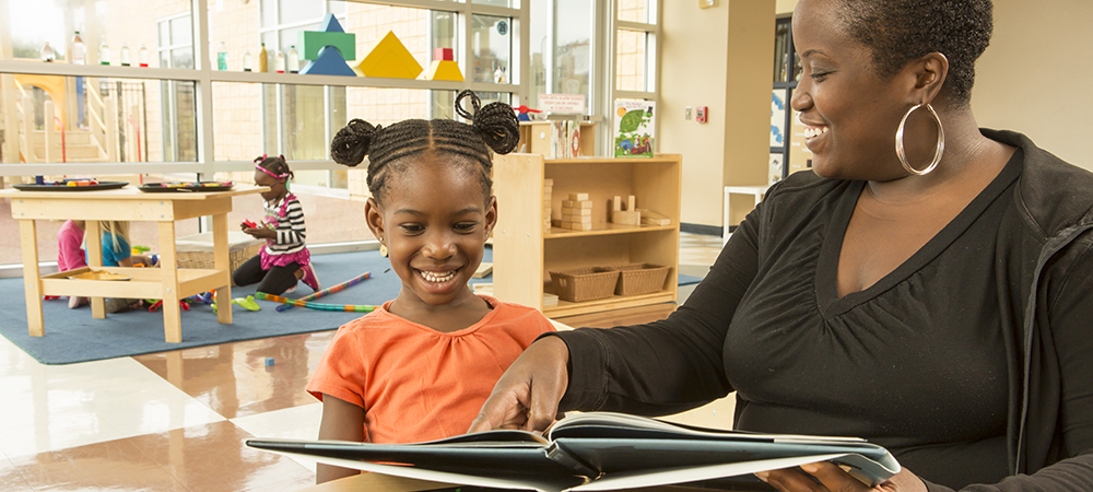 Early Childhood Care student reading to child.