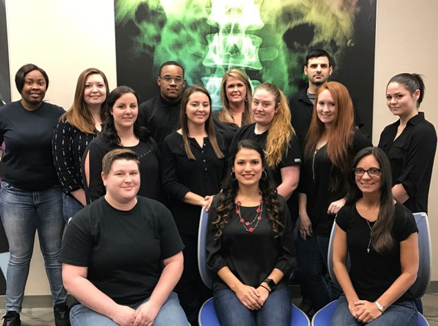 Pictured in black t-shirts and blue jeans are the thirteen graduates of the Radiologic Technology program that passed their certification exam.