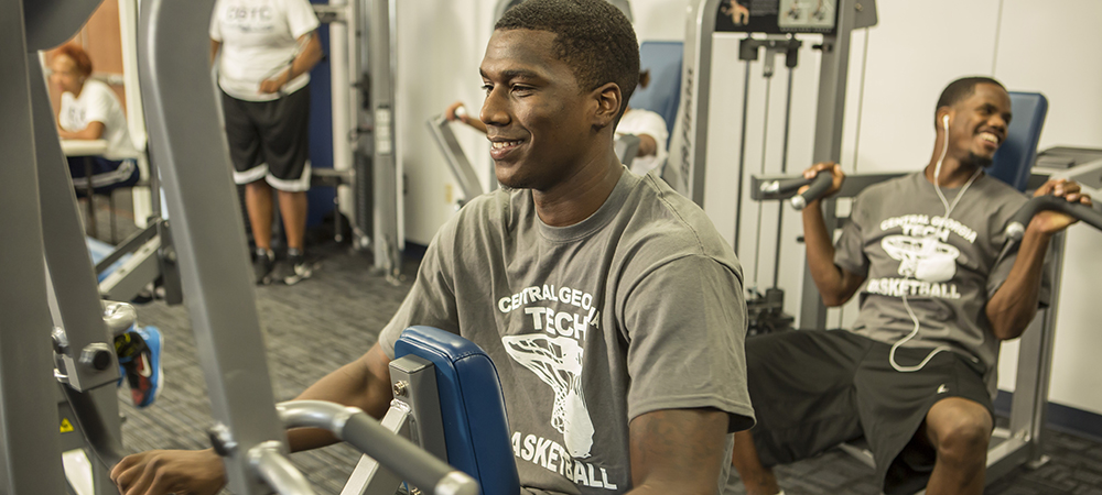 Students using wellness center equipment