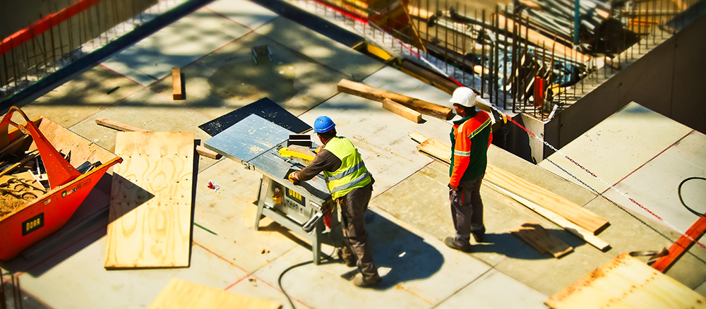 Two men in hardhats on construction site