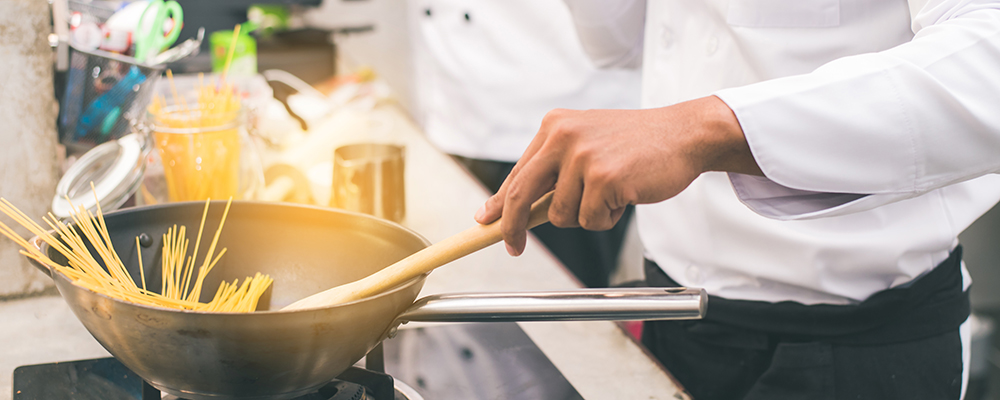 Chef preparing food in the kitchen of a restaurant