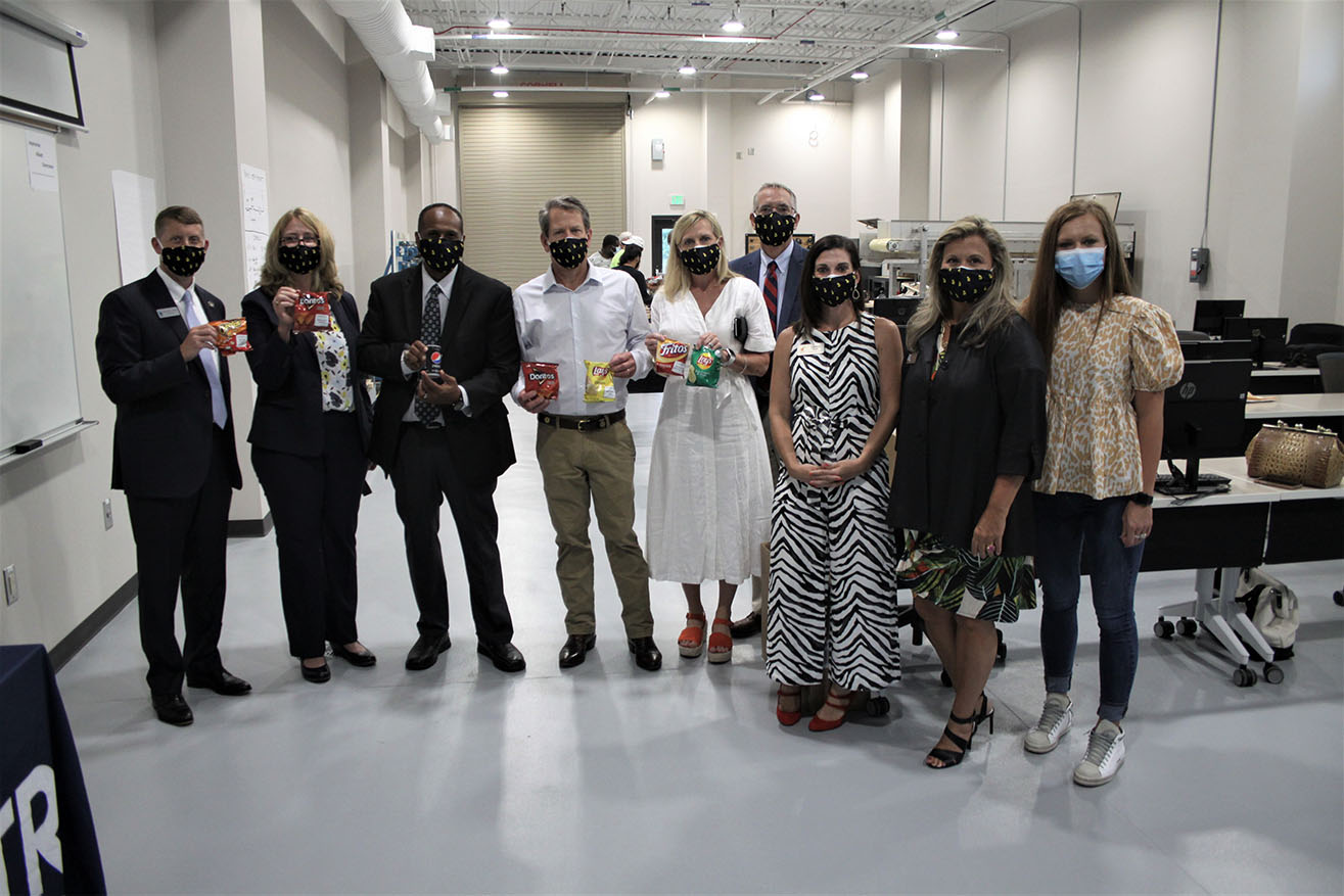 Governor Brian Kemp alongside First Lady, Marty Kemp, (center) visit the Georgia VECTR Center expansion to learn about the partnership in Industrial Systems with Frito Lay to produce a pipeline of veteran and active duty workers. 